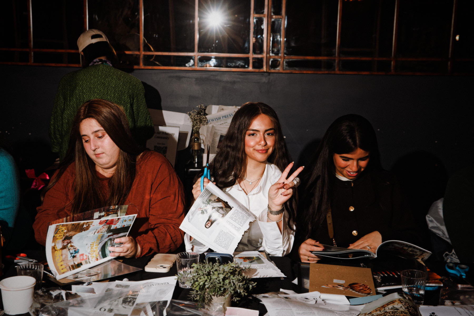 A guest creating her vision board collage