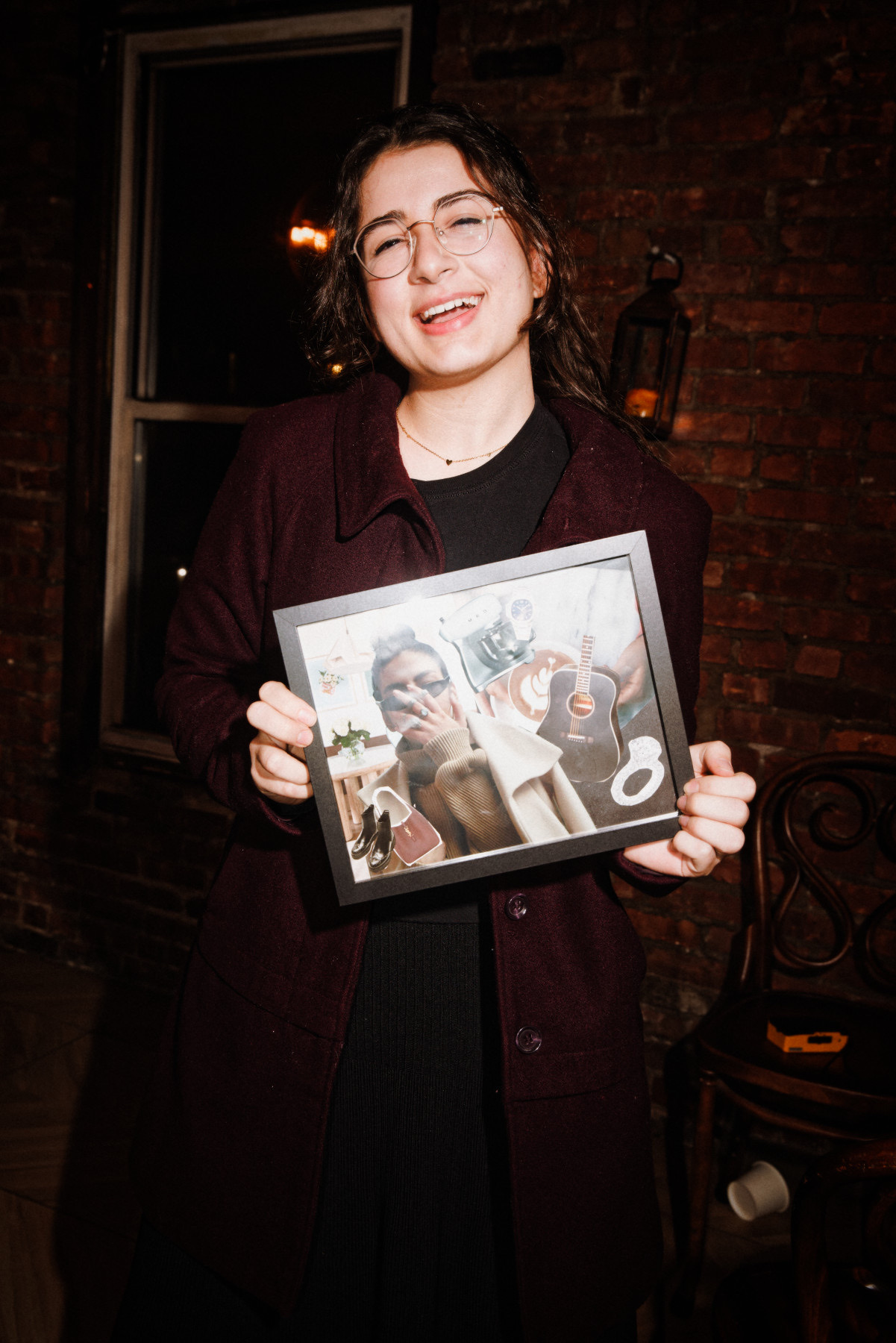 A guest holding her completed vision board