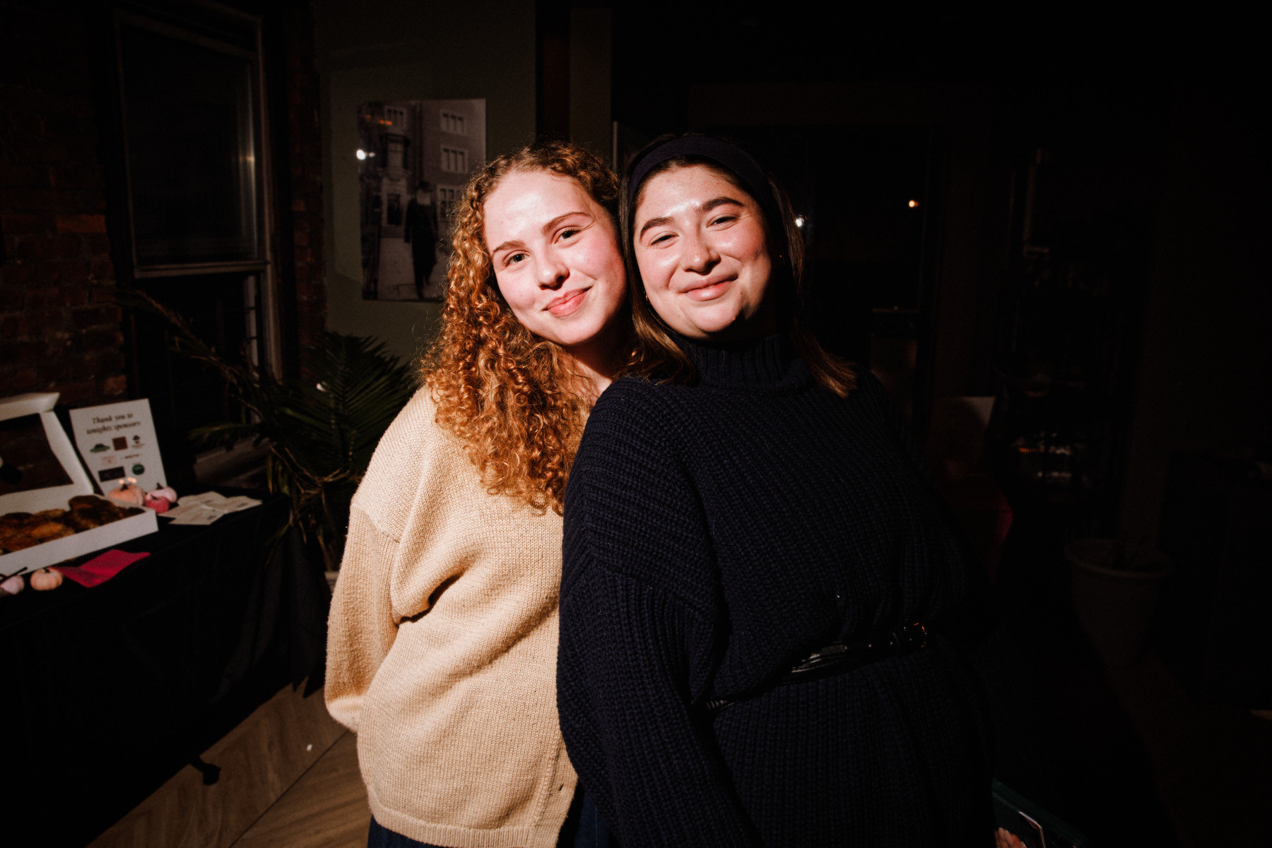 Two friends smiling at the event
