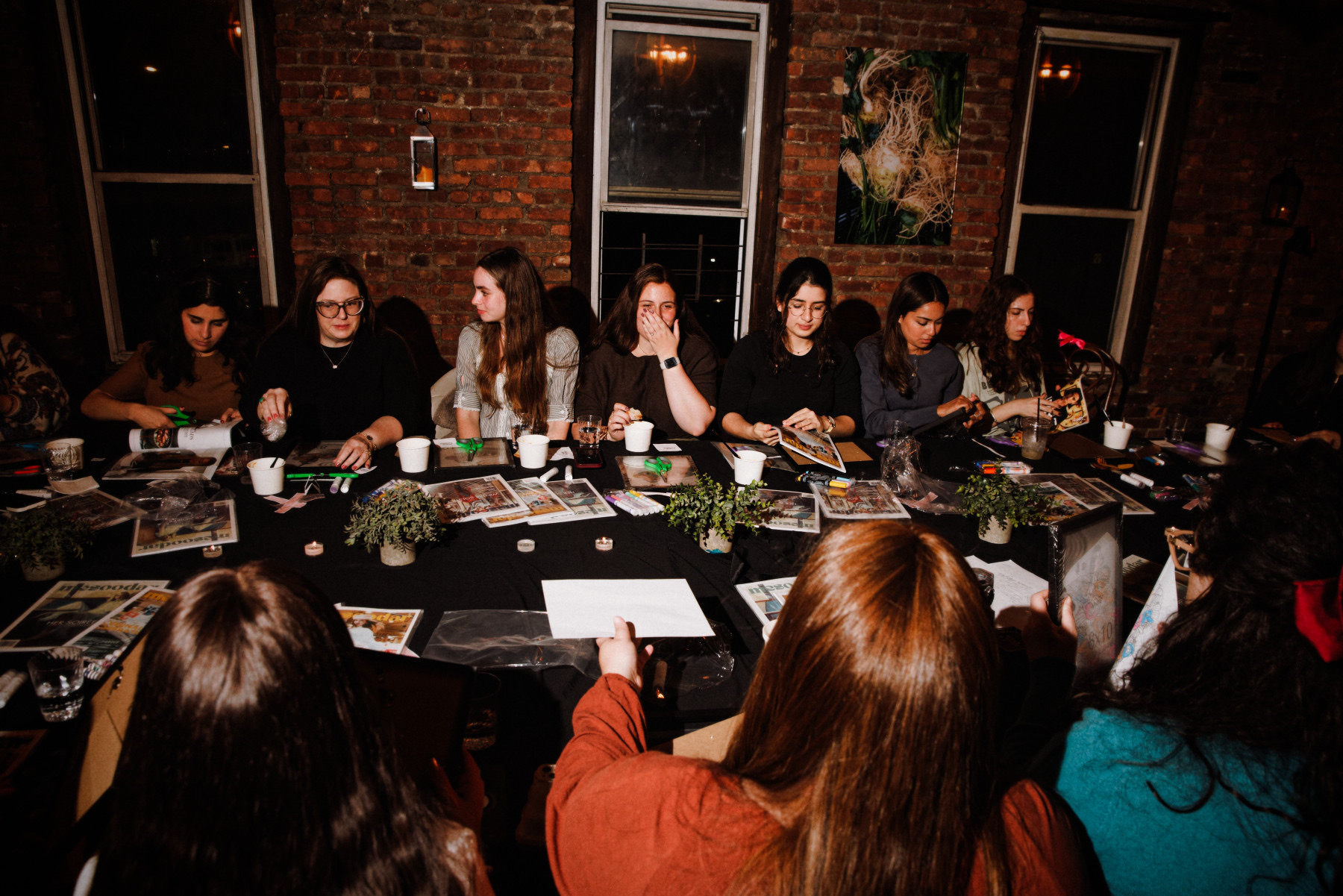 Women creating vision boards around the table